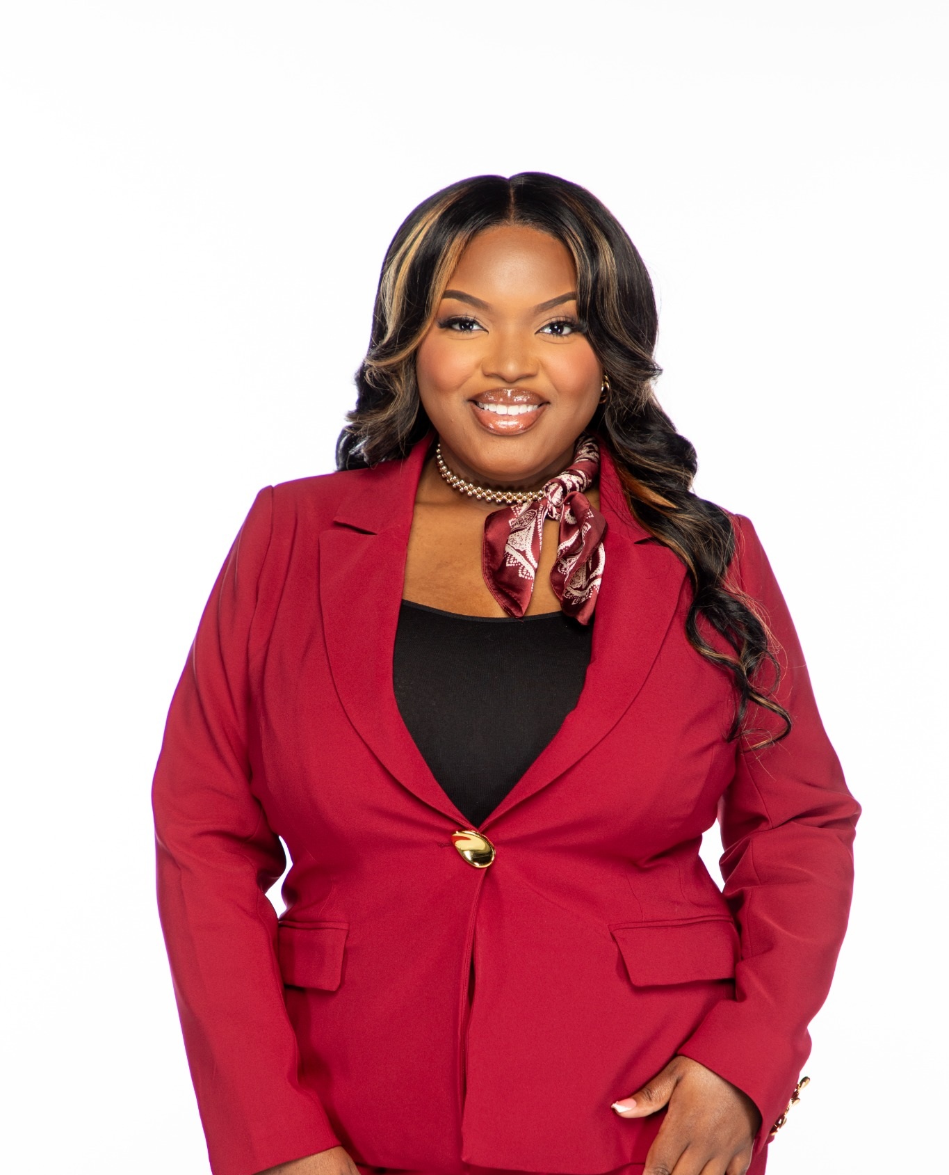 Jafara Brand smiling in a burgundy suit